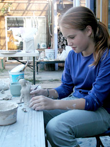 girl sculpting clay figure